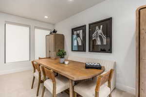 Dining area featuring light carpet and recessed lighting