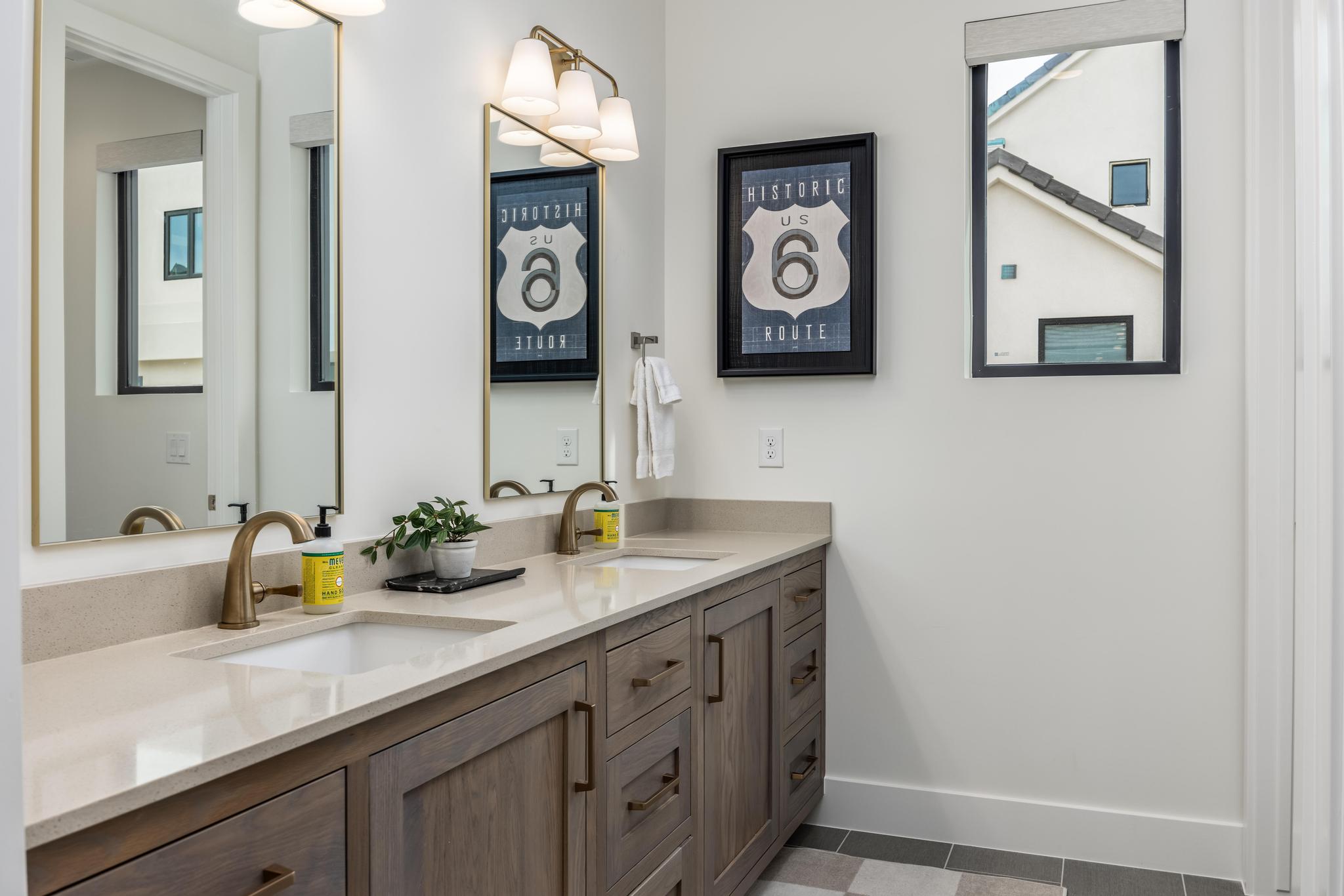 Bathroom with double vanity and light tile patterned floors