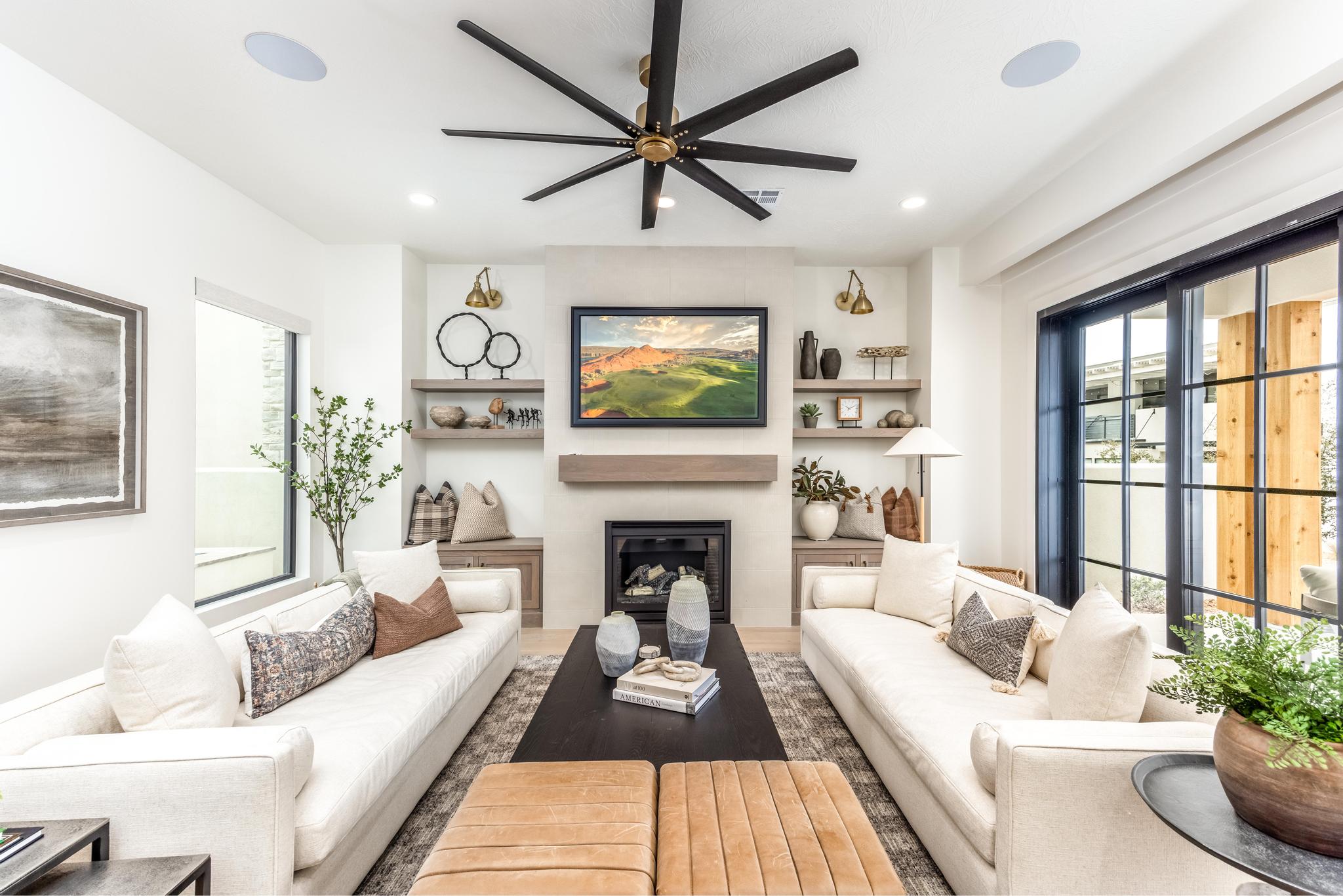 Living area featuring a large fireplace, ceiling fan, recessed lighting, and wood finished floors