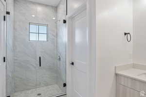 Bathroom with vanity and a shower stall