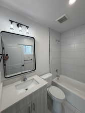 Bathroom featuring vanity, shower / tub combination, and recessed lighting