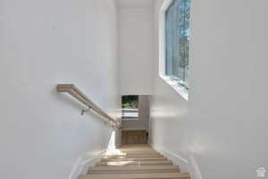 Staircase featuring wood finished floors and baseboards