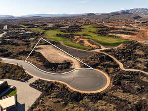Aerial overview of property's location with a mountain backdrop and property parcel outlined