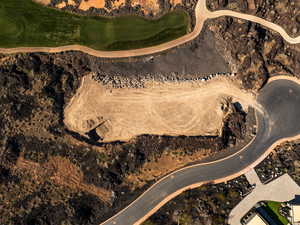 Aerial view of property and surrounding area with a golf club