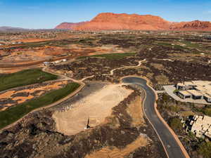 Aerial perspective of suburban area with a mountain backdrop and a golf course