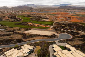 Aerial view of property and surrounding area featuring a mountain backdrop