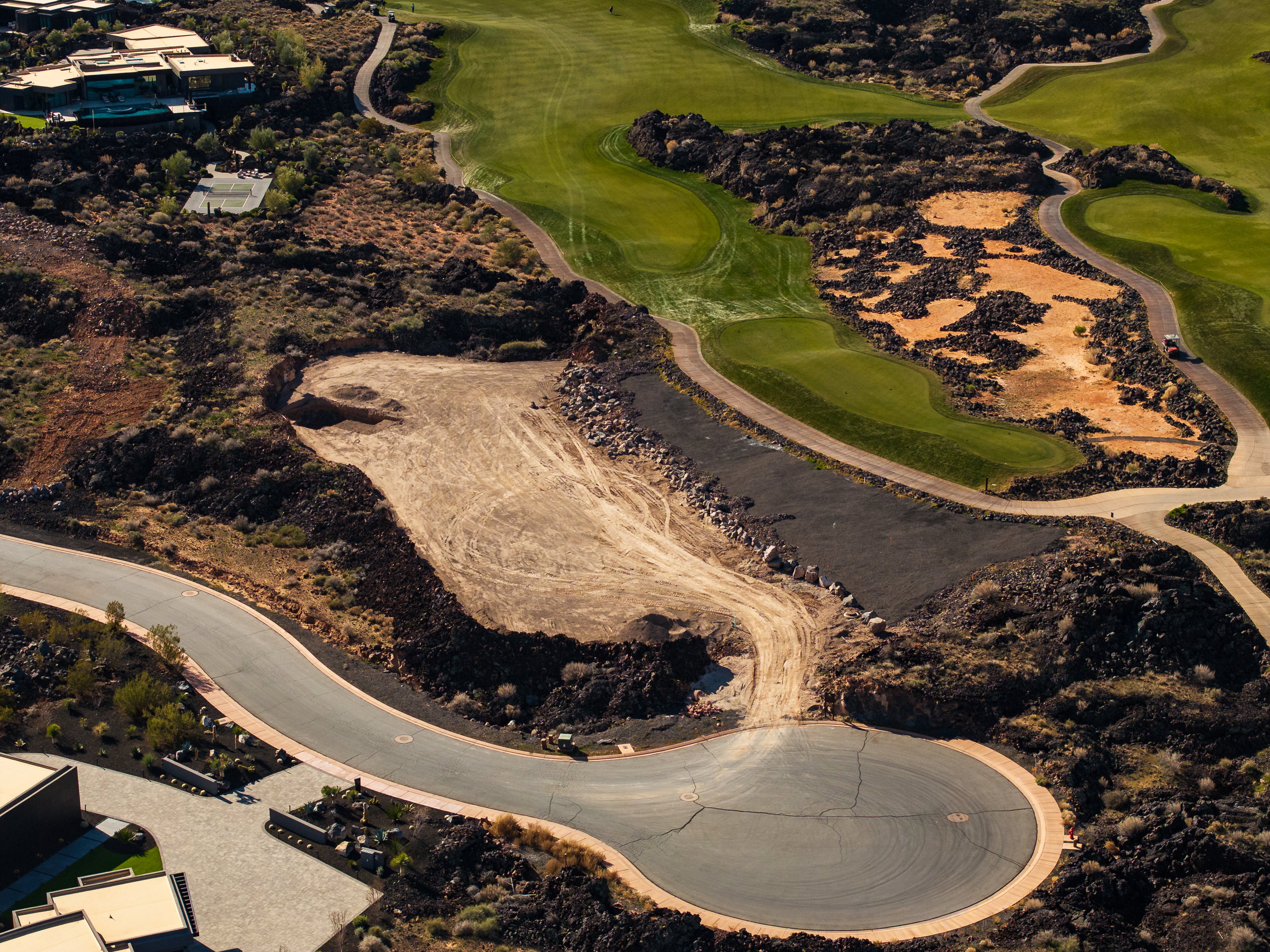 Aerial view of property and surrounding area with a local golf course