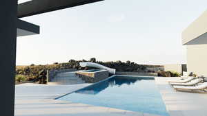 View of pool with an infinity pool and a patio