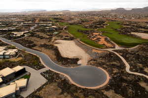 Aerial view of property and surrounding area with a mountain backdrop and a golf club