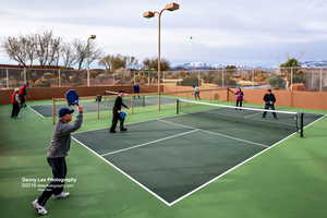View of tennis court with community basketball court