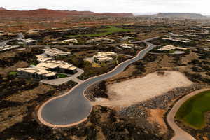 Aerial view of property and surrounding area featuring nearby suburban area and a mountainous background