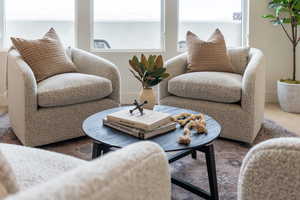 Living area with wood finished floors and baseboards