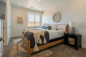 Carpeted bedroom with baseboards and recessed lighting