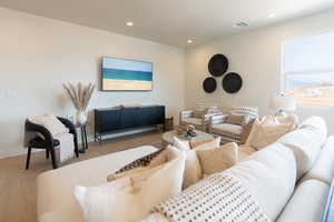 Living area with wood finished floors and recessed lighting