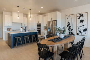 Dining area featuring recessed lighting and light wood-style flooring