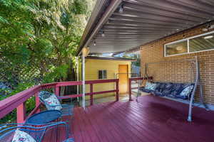 View of fenced deck and outdoor covered patio.