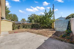 RV pad behind the gate, storage shed, and fertile garden area with various fruit and greenhouse, with full sprinkler system.