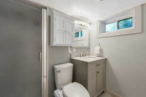 Updated daylight basement bathroom with updated vanity, paint, and shower.