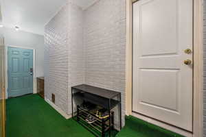 Enclosed mudroom with 8 custom lockers - buffering the attached garage, and interior entrance.
