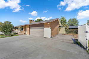 View of front of property, showcasing the extra parking in the driveway, and parking behind the gate - off of the fertile garden area.