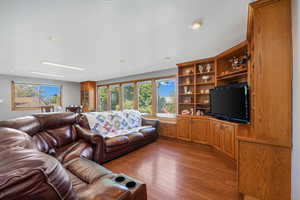 Great room connected to Kitchen, featuring healthy amount of natural light, hardwood flooring, and recessed lighting.