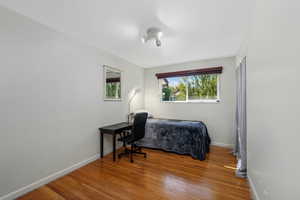 Main-floor bedroom with hardwood finished floors.