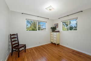 Main-floor ensuite bedroom with light hardwood flooring.