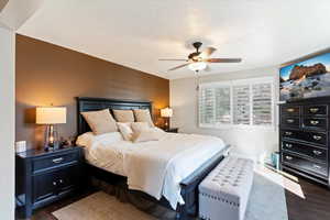 Primary suite on main level with ceiling fan and ensuite bathroom