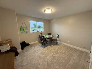 Dining area featuring light carpet and baseboards