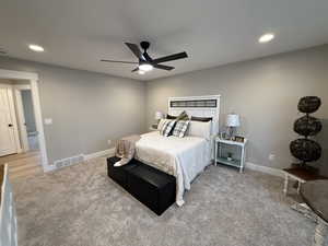 Bedroom with recessed lighting, a ceiling fan, and light carpet