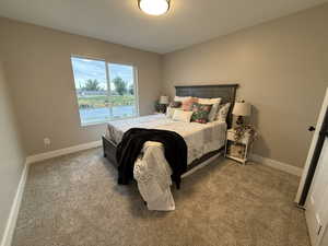 Carpeted bedroom with baseboards