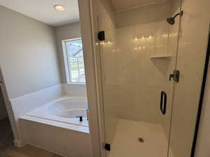Full bath featuring a shower stall and a garden tub