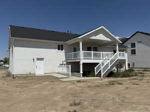 Rear view of property with a patio, stairway, a deck, a shingled roof, and stucco siding