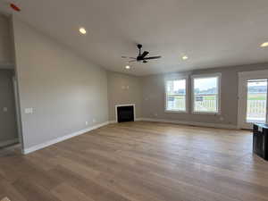 Unfurnished living room featuring a fireplace, recessed lighting, light wood-style floors, and ceiling fan