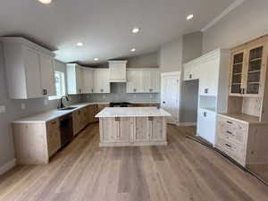 Kitchen featuring a kitchen island, vaulted ceiling, stainless steel appliances, recessed lighting, and light wood finished floors