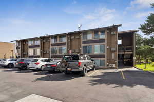 View of property featuring uncovered parking