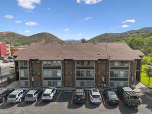 View of property featuring a mountain view and uncovered parking