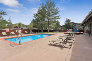 Community pool featuring a patio
