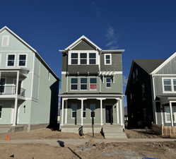 View of front facade with a porch and stucco siding