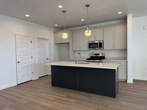 Kitchen with hanging light fixtures, gray cabinetry, stainless steel appliances, dark wood-style flooring, and recessed lighting