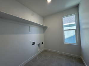 Laundry room featuring washer hookup and light tile patterned flooring