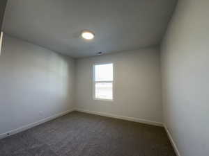 Unfurnished room featuring carpet floors and a textured ceiling