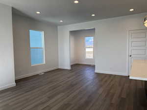 Empty room featuring dark wood-style floors and recessed lighting