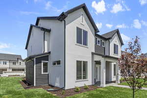 View of property exterior with a yard and stucco siding