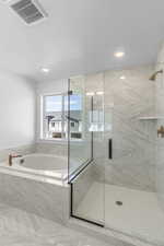 Full bathroom with a marble finish shower, a garden tub, and recessed lighting