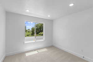 Empty room featuring carpet flooring and recessed lighting