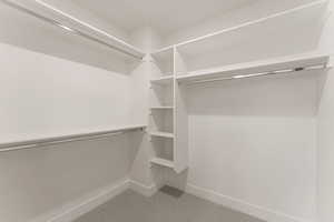 Walk in closet with light colored carpet