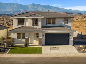 Traditional-style home with a porch, a mountain view, stucco siding, driveway, and a tile roof