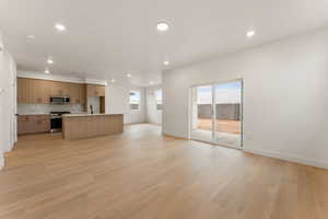 Unfurnished living room with recessed lighting and light wood-type flooring