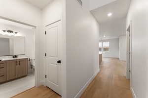 Hallway featuring light wood-type flooring and recessed lighting